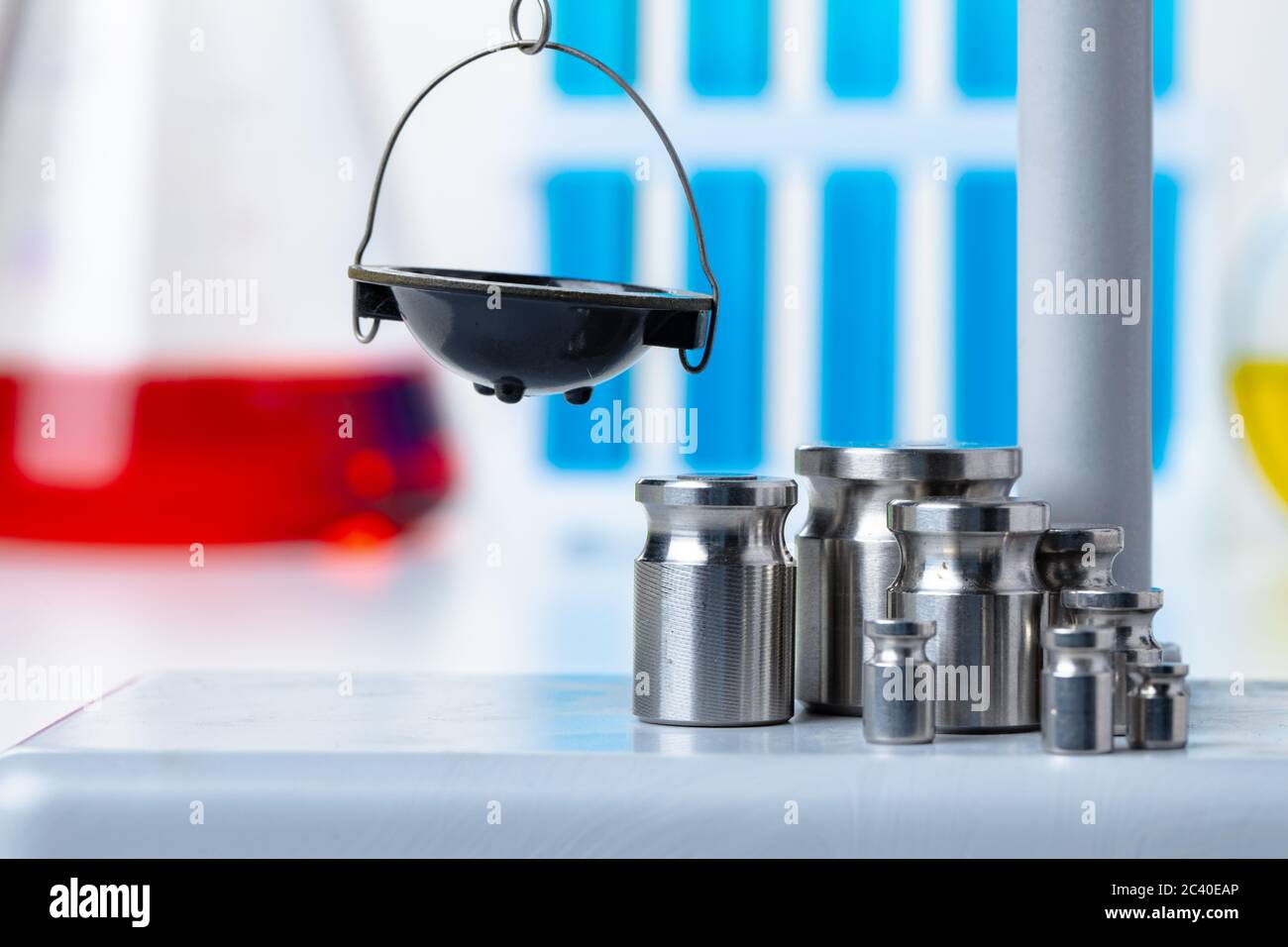 Laboratory scales with weights against test tubes Stock Photo Alamy