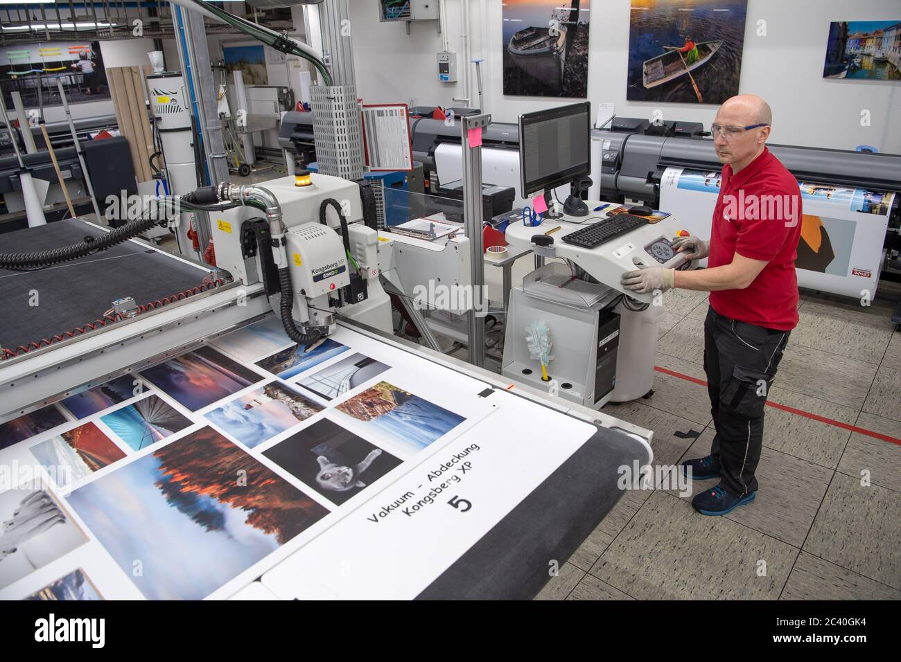 Oldenburg Germany th May An Employee Of The Photo Service Provider Cewe Works On The Cutting Of The Printed Wall Pictures Credit Sina Schuldt Dpa Alamy Live News Stock Photo Alamy