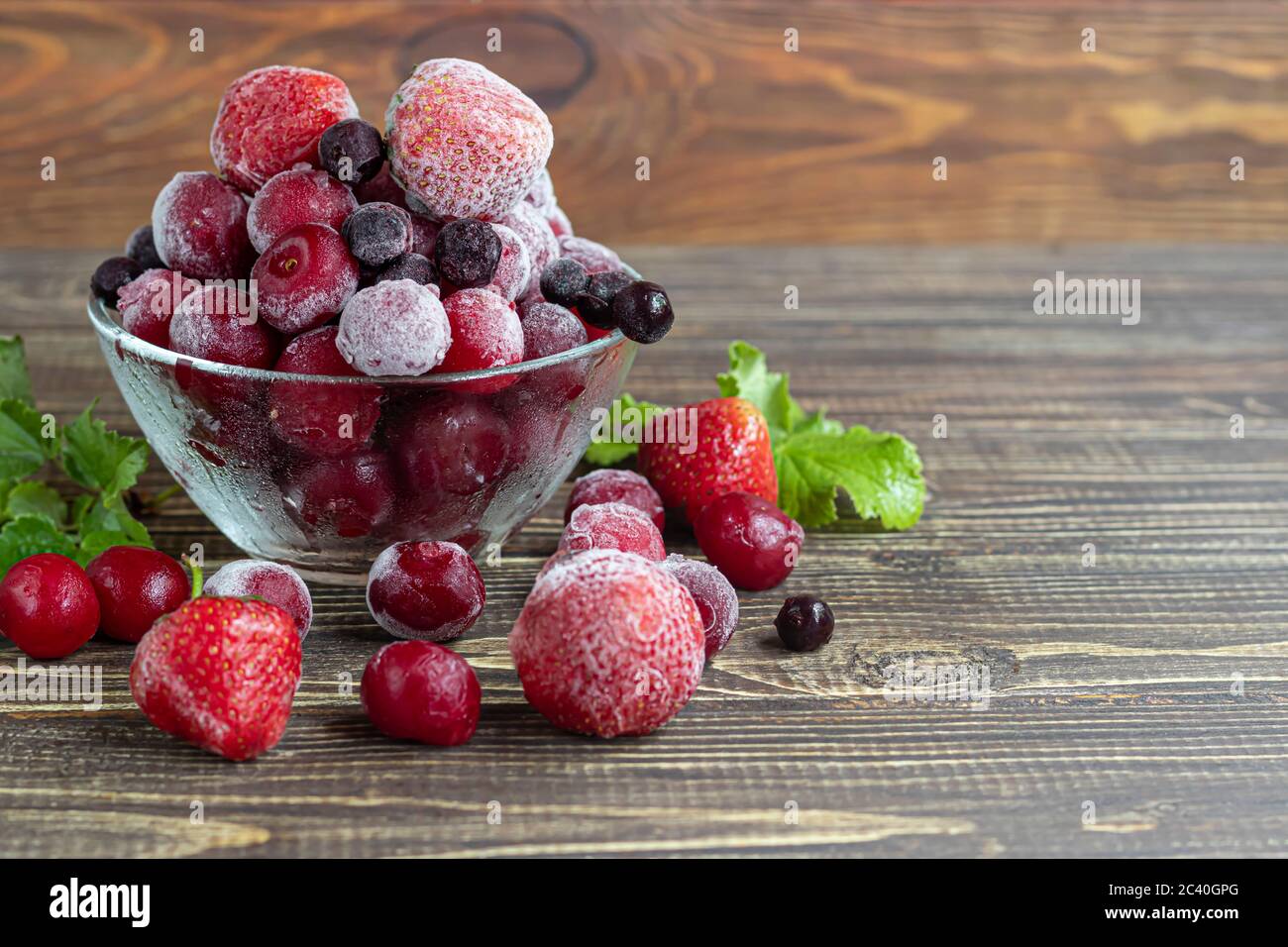 Frozen fruits. Frozen fruit mixture of currants, cherries and strawberries.  Vitamin Blend. On a dark background. Copy space Stock Photo - Alamy