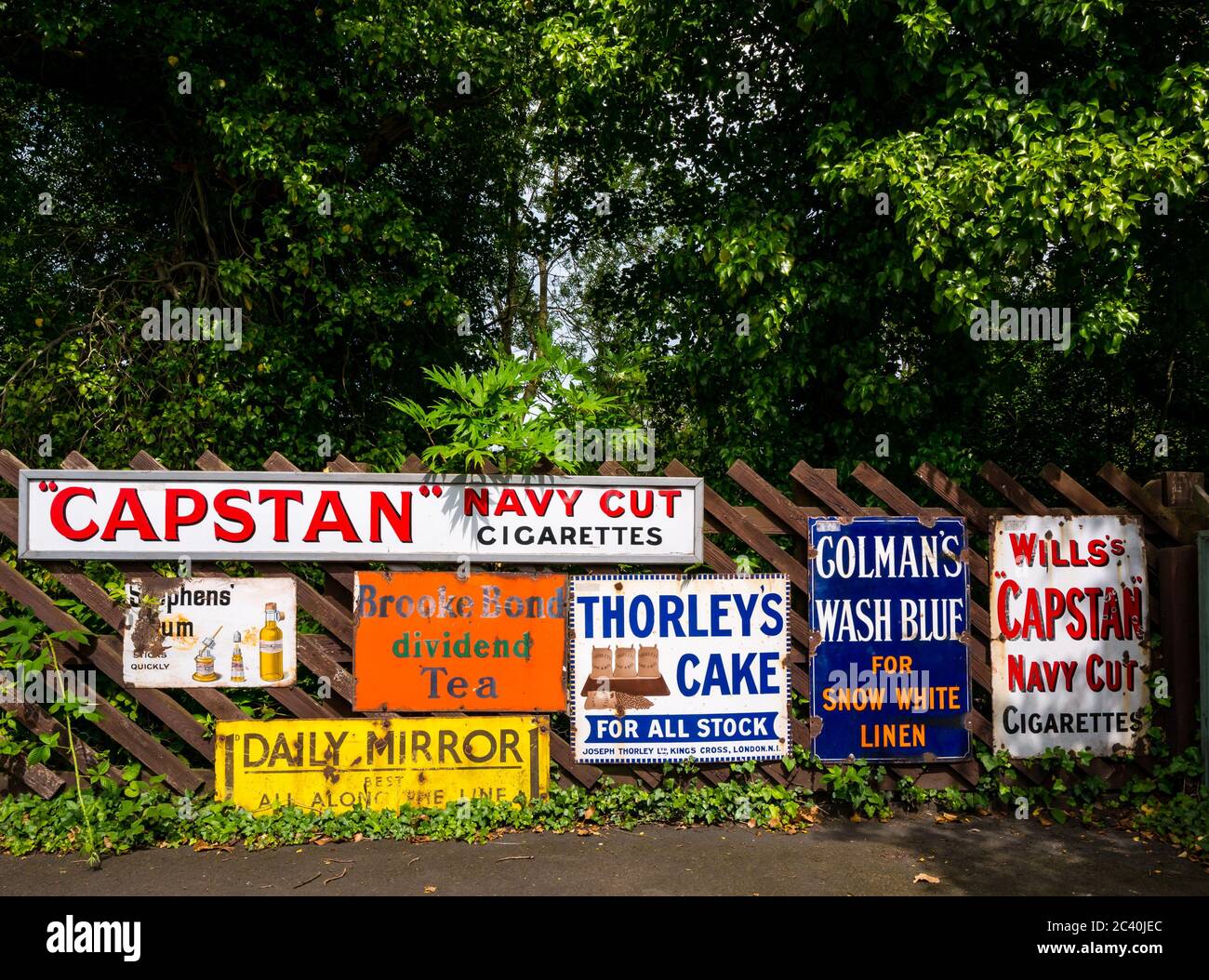 Old fashioned vintage advertising signs: Brooke Bond tea, Daily Mirror & Capstan Navy Cut, England, UK Stock Photo