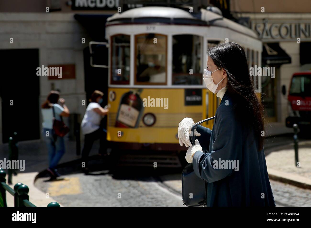 June 23, 2020, Lisbon, Portugal: A man wearing a face mask walks in Lisbon, Portugal, on June 23, 2020, during the COVID-19 Coronavirus pandemic. The Government applies today new mandatory confinement measures to the whole Lisbon metropolitan area, due to a significant increase in Covid-19 cases in recent weeks. Among the main restrictions is the return of the ban on gatherings with more than ten people, the strengthening of the supervision of shopping centres and the general closure of stores at 20:00, with the exception made to restaurants for meal service. (Credit Image: © Pedro Fiuza/ZUMA Stock Photo