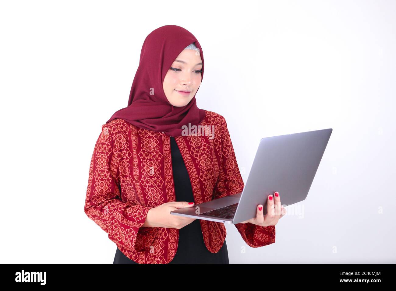 Young Asian Islam woman is standing and smiling face with hand holding ...