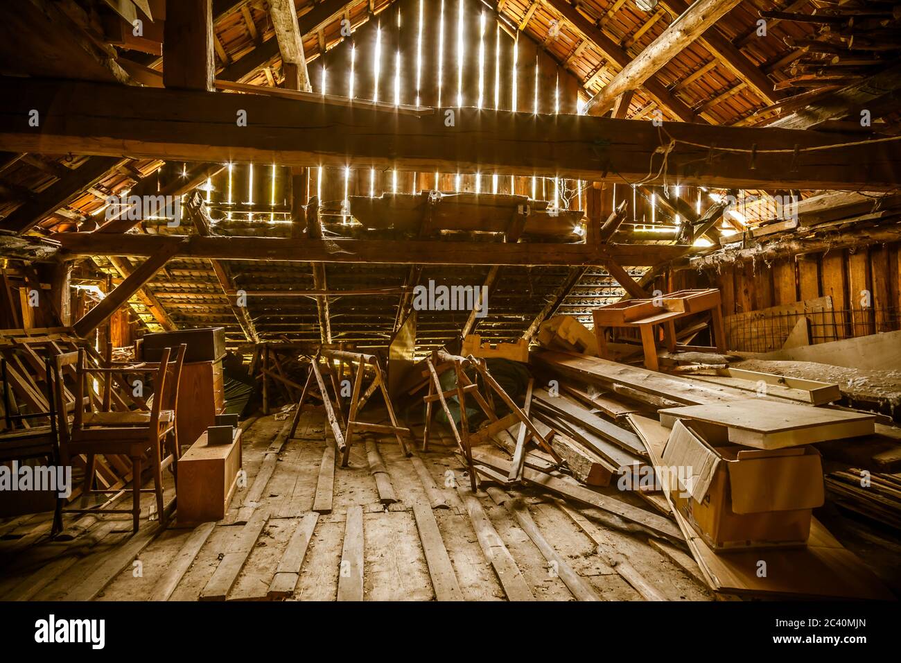 Interior of old wooden shed with scrap wood with sunrays. Old barn. Stock Photo