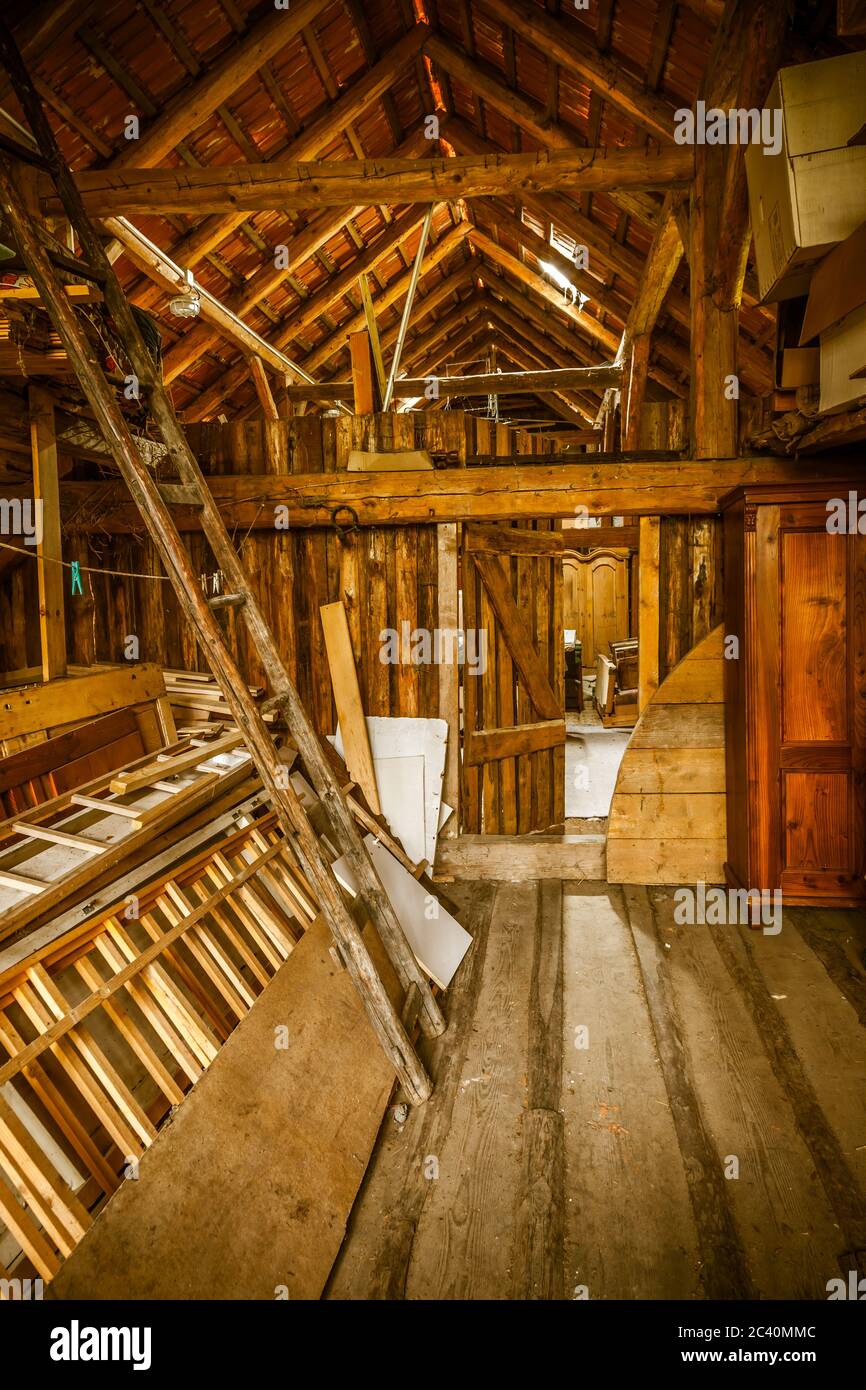 Interior of old wooden shed with scrap wood with sunrays. Old barn. Stock Photo