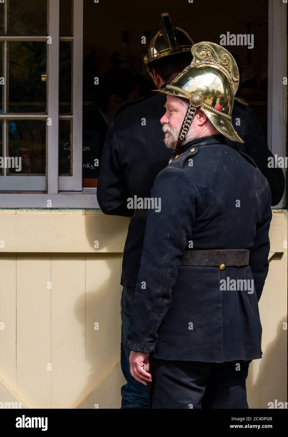 Men dressed in vintage fireman uniform with brass helmets, Great North Steam Fair, Beamish Museum, Durham County, England, UK Stock Photo