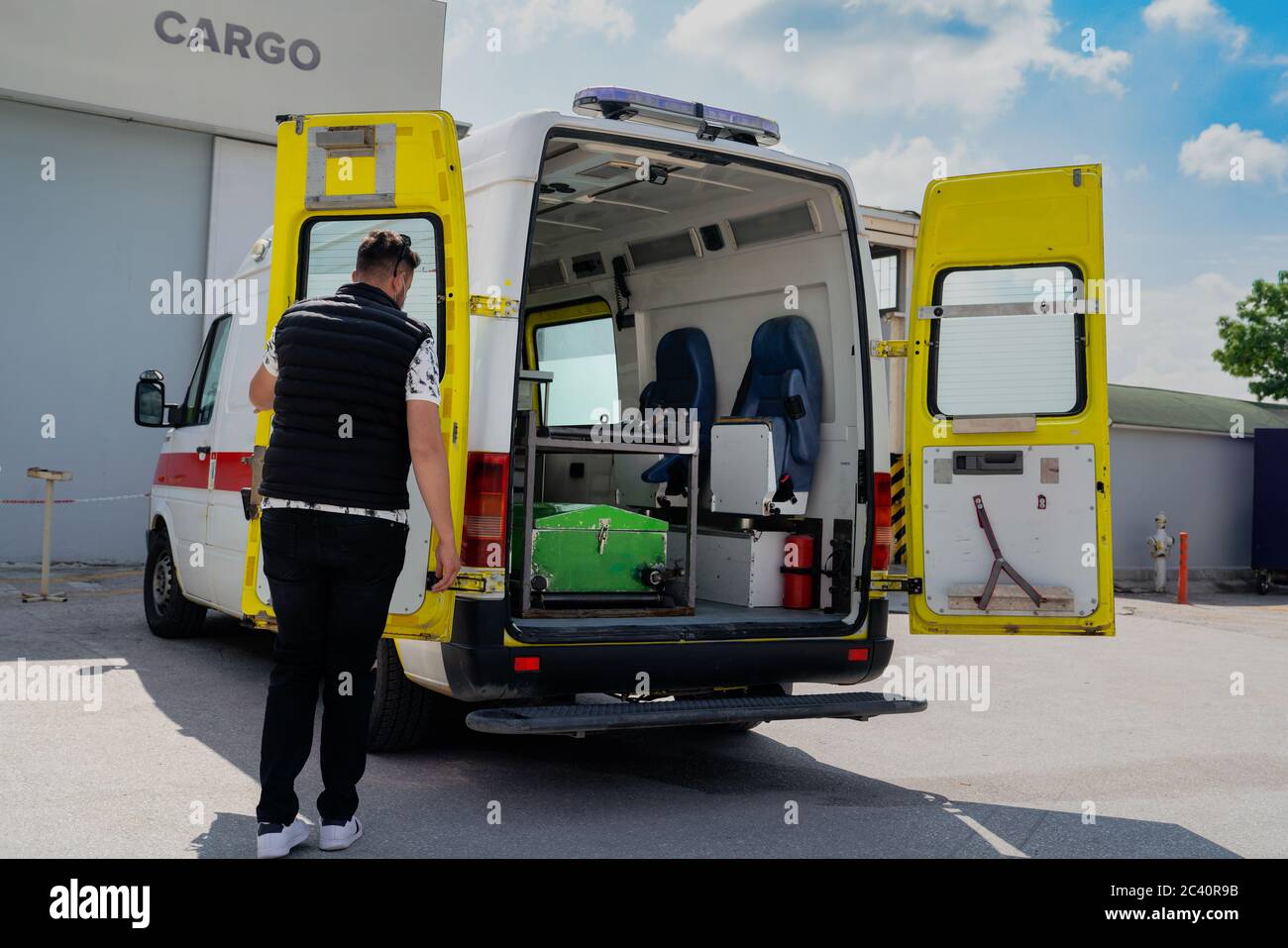Coffin in the funeral coach with the driver Stock Photo Alamy