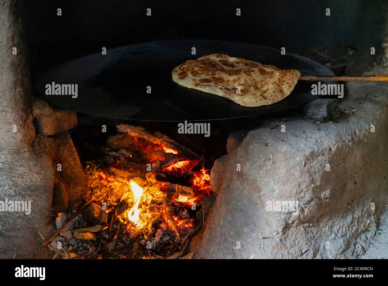 Making gozleme bread on wooden fire in rural  region in Turkey Stock Photo
