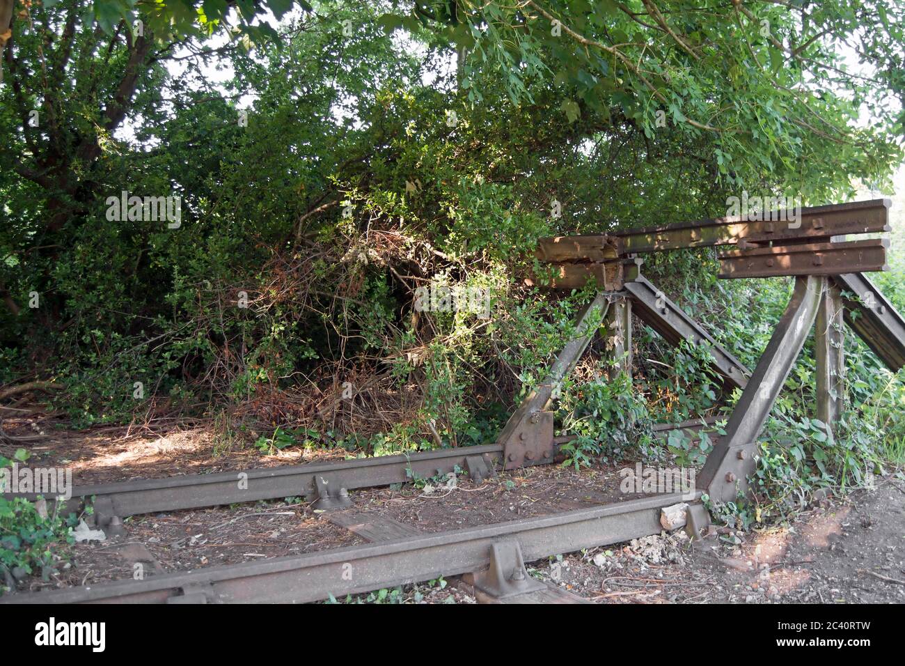 abandoned section of rail track and buffer at twickenham junction rough, former site of twickenham station, twickenham, middlesex, england Stock Photo