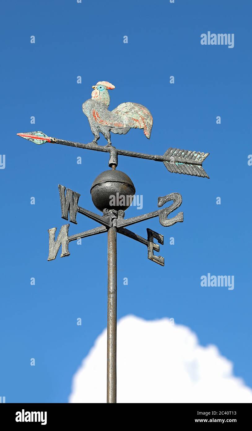 wind vane for indicating the wind direction with the blue sky background and the letters of the cardinal points Stock Photo