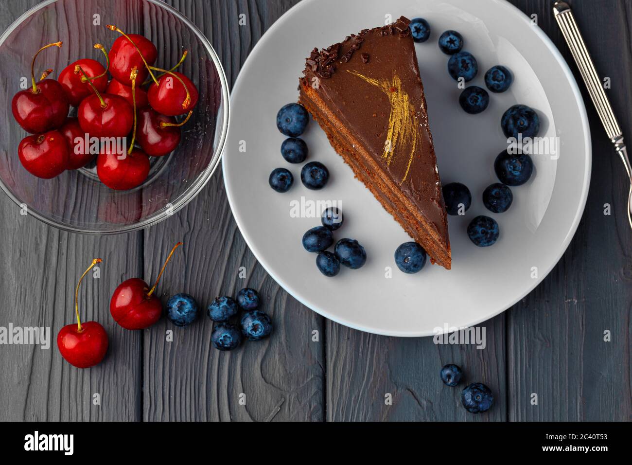 Piece of chocolate cake served with fresh berries Stock Photo - Alamy
