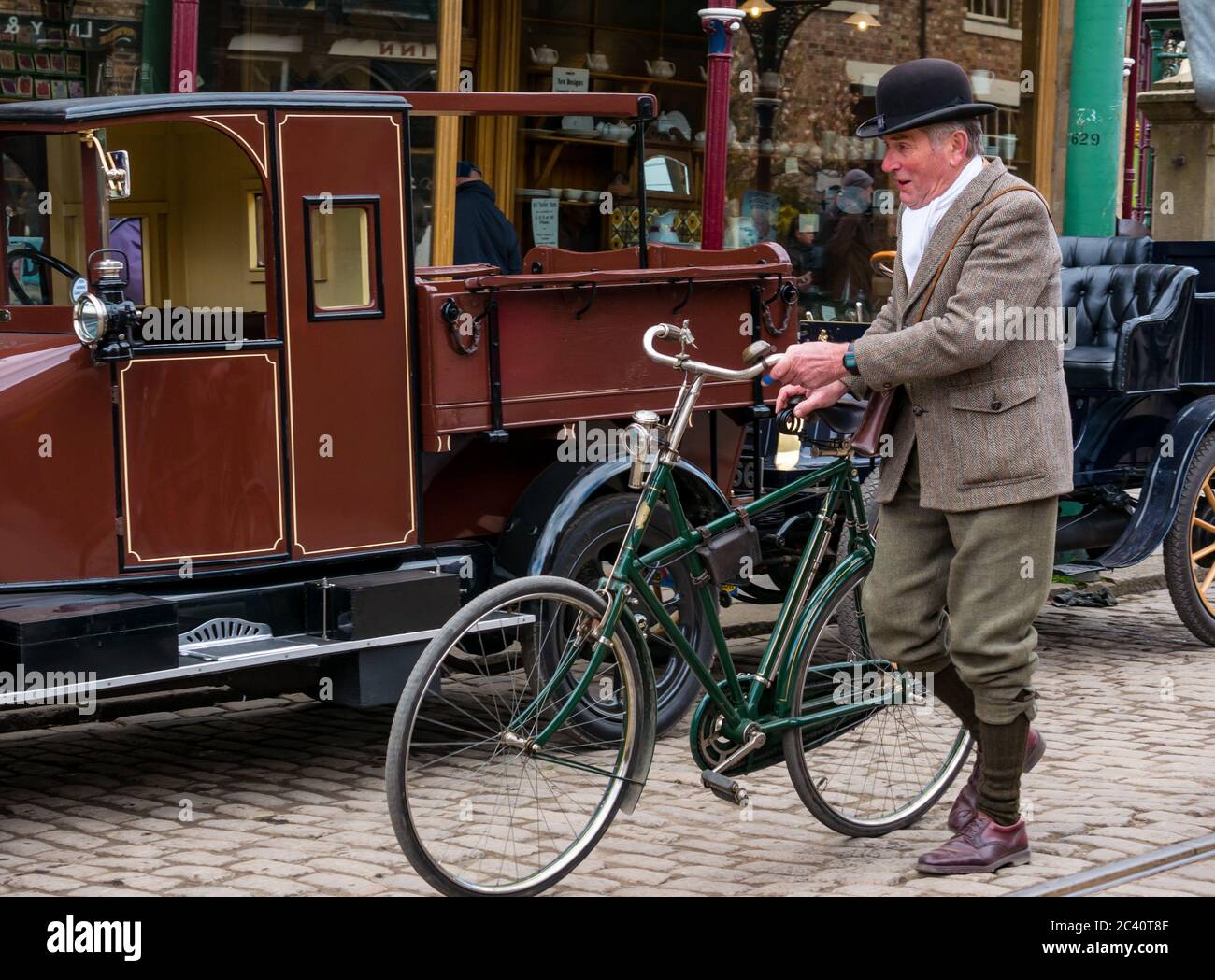 Man in period costume and old fashioned vintage bicycle, Beamish Museum, Durham County, England, UK Stock Photo