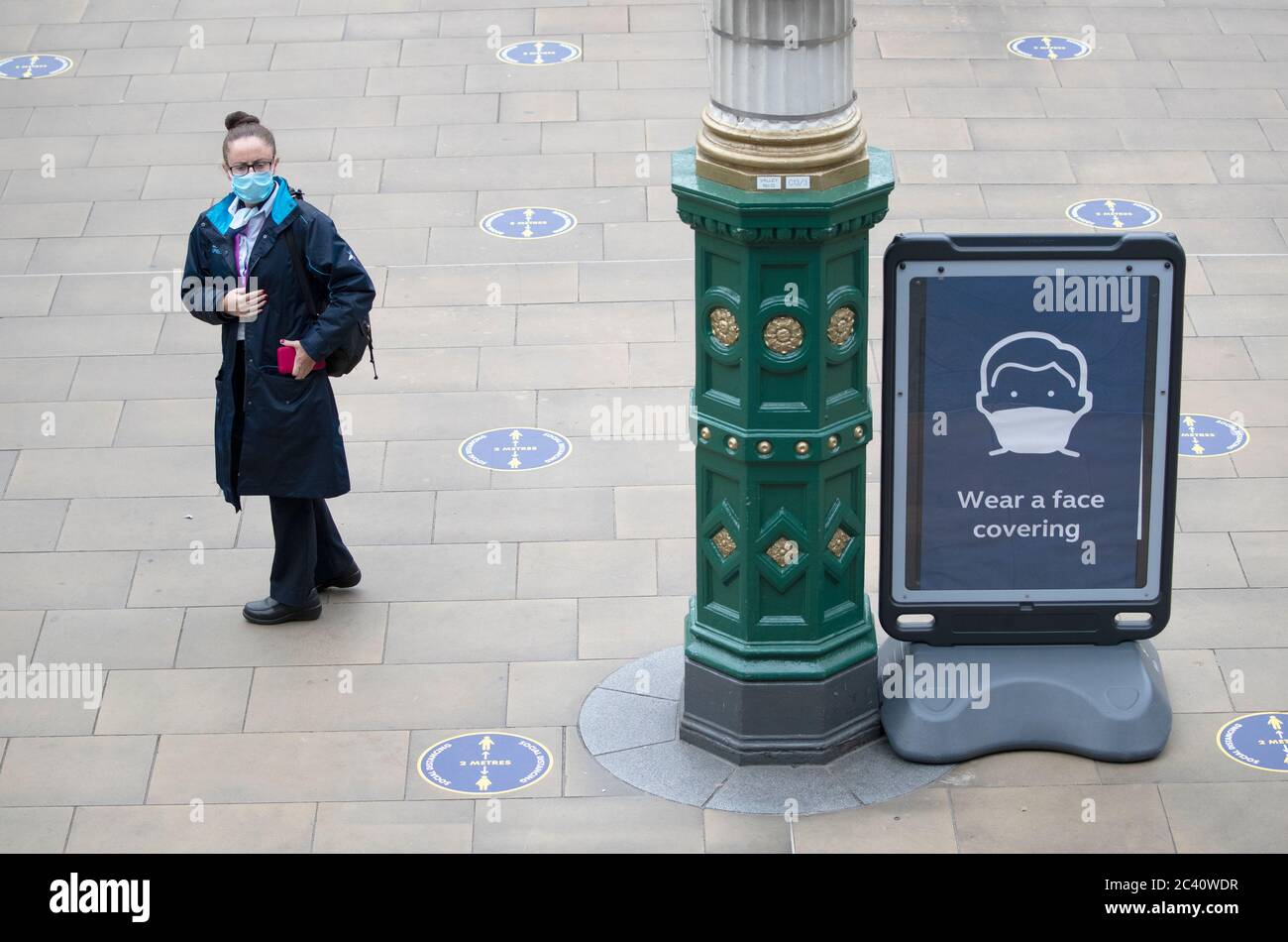 A member of the public wears a protective face mask inside Waverley