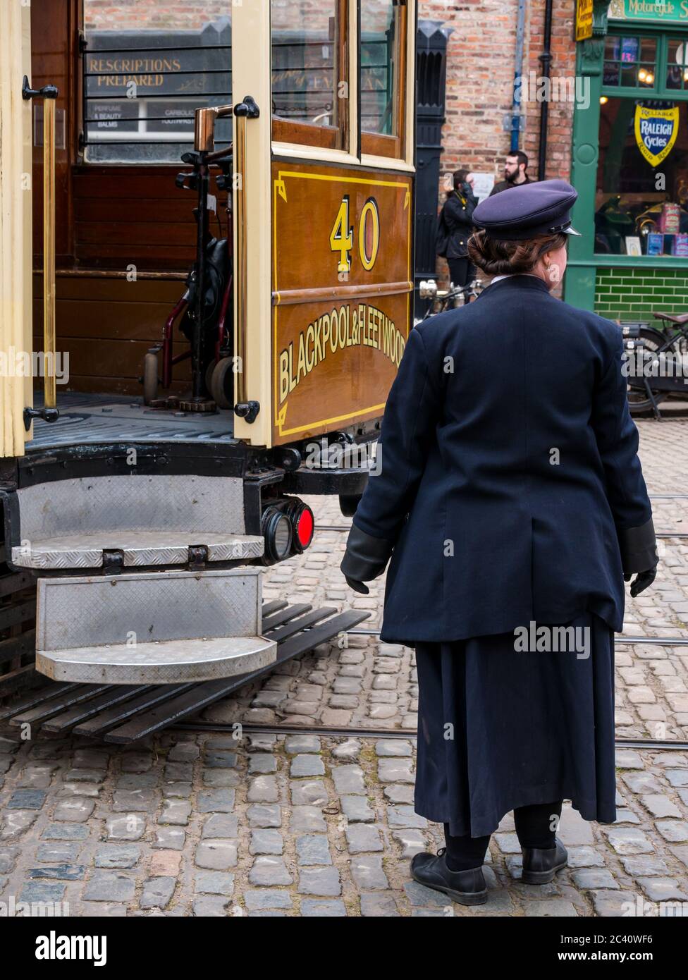 Woman dressed in period costume as tram conductor, Beamish Museum, Durham County, England, UK Stock Photo