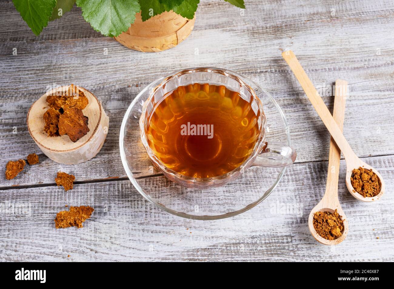 Healing infusion of birch mushroom chaga in figured glass cup and chaga ...