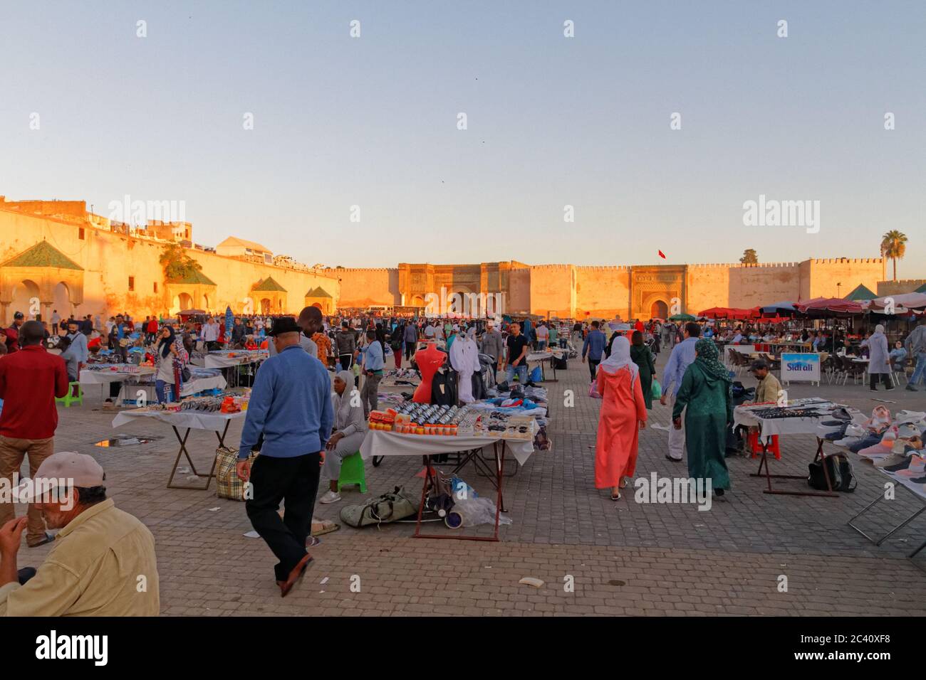 MEKNES, MOROCCO. Okt 11, 2018. Market at El Hedim Square and Bab Mansour gate in Meknes, Morocco. Warm colours sunset. Stock Photo