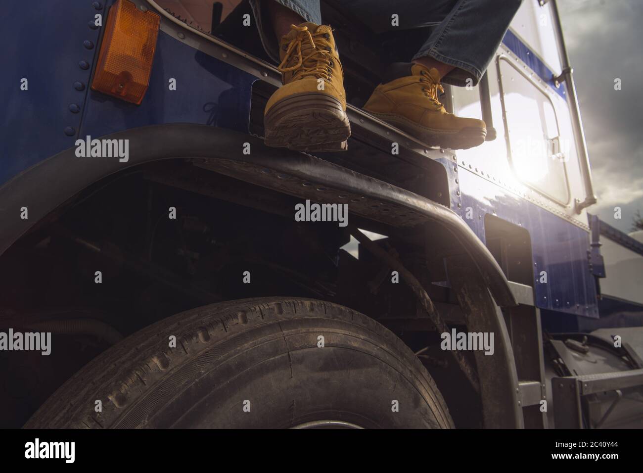 Commercial Truck Driving Job Concept. Driver Inside Semi Truck Tractor