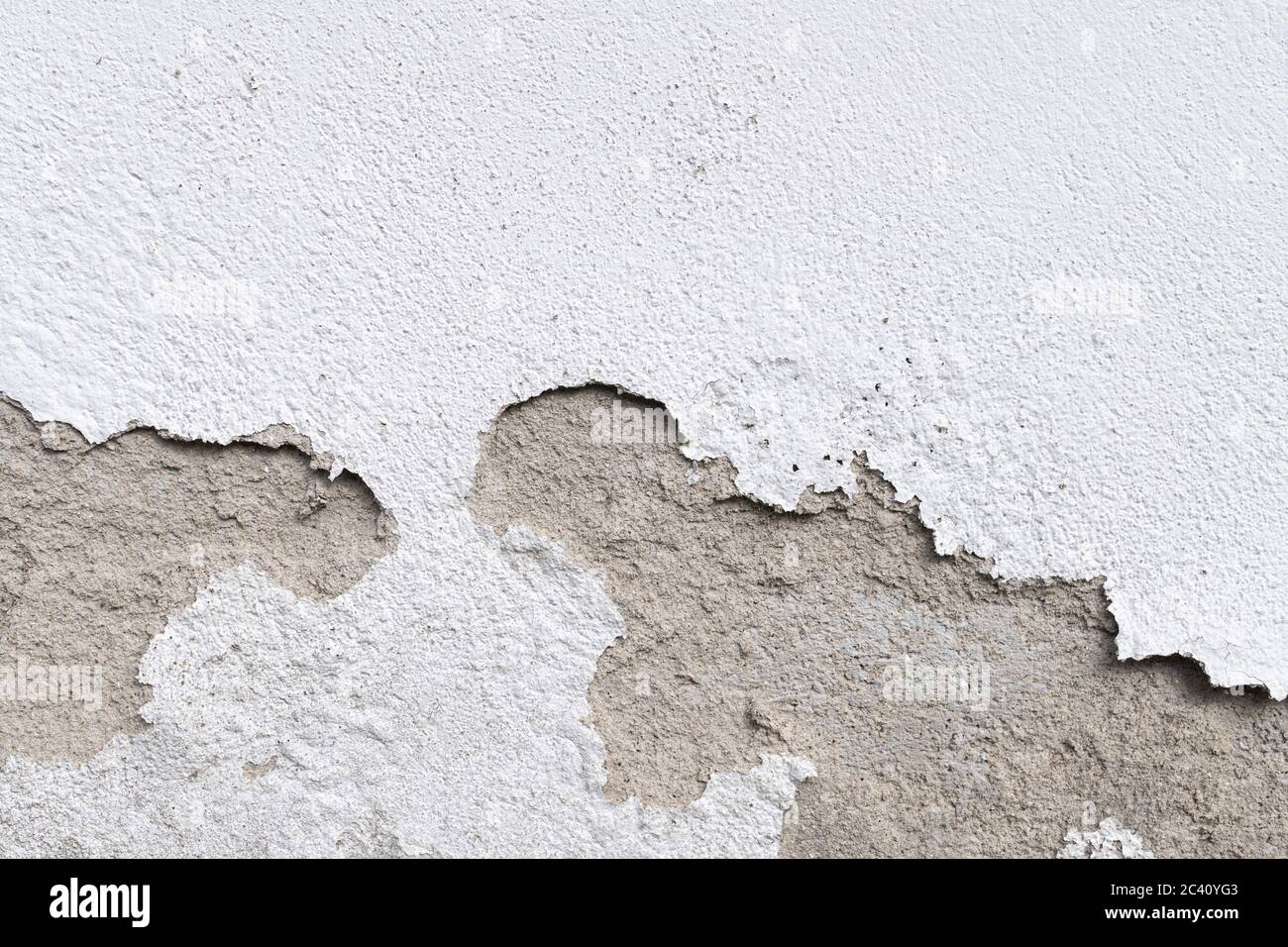 Wall damage on outdoor. Plaster and paint clog, surface damage. Peeled