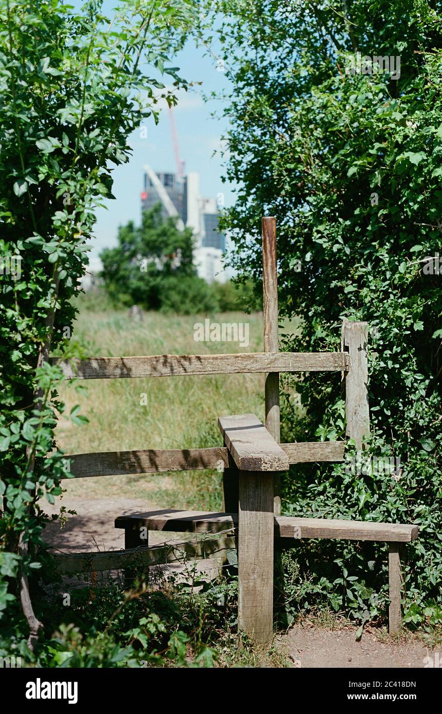 Stile in Gillespie Park conservation area, near Arsenal, London UK, with the new City North housing development at Finsbury Park in the far distance Stock Photo