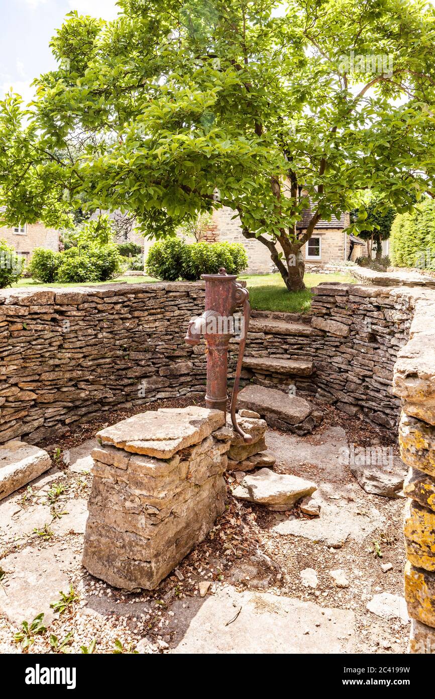 The old water pump in the Cotswold village of Barnsley, Gloucestershire UK Stock Photo