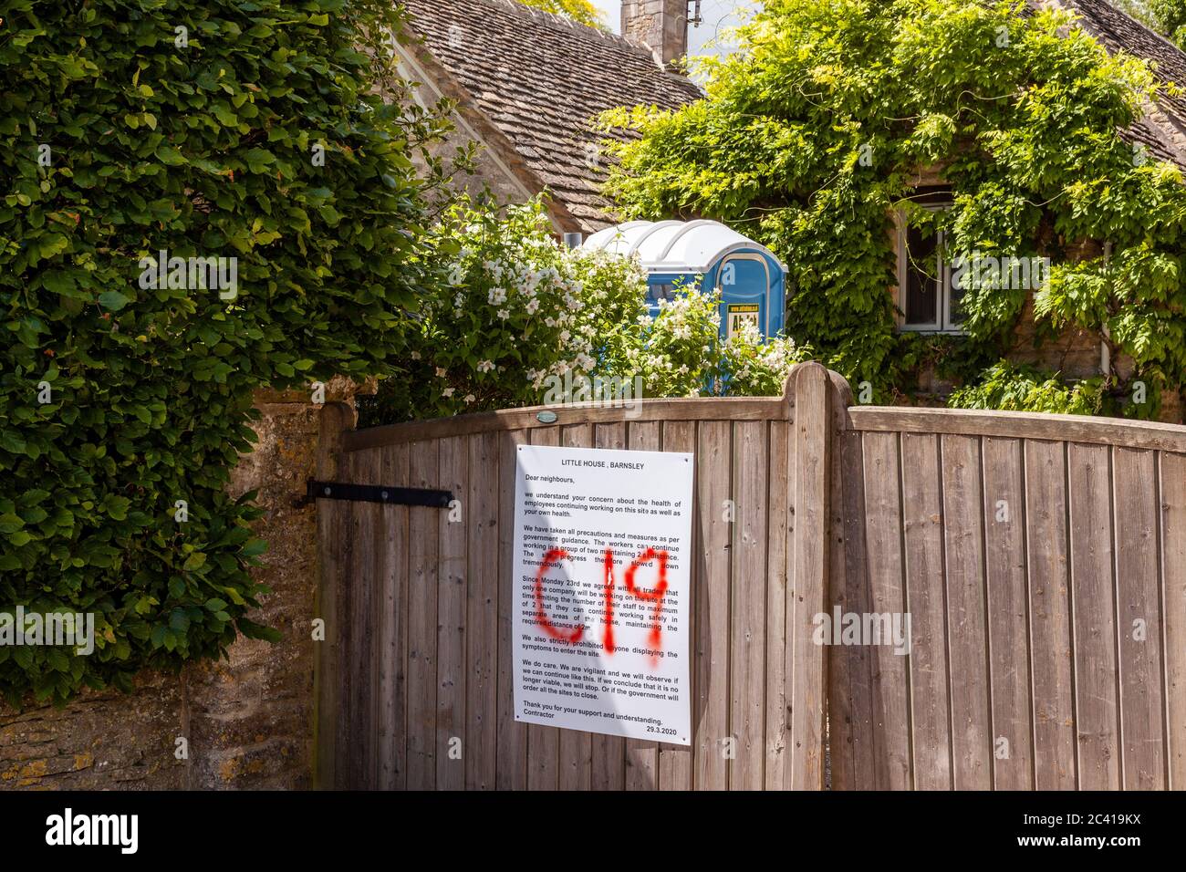 A notice on the gate of a property undergoing construction work assuring local residents of safe working practices during the Covid 19 pandemic. Stock Photo