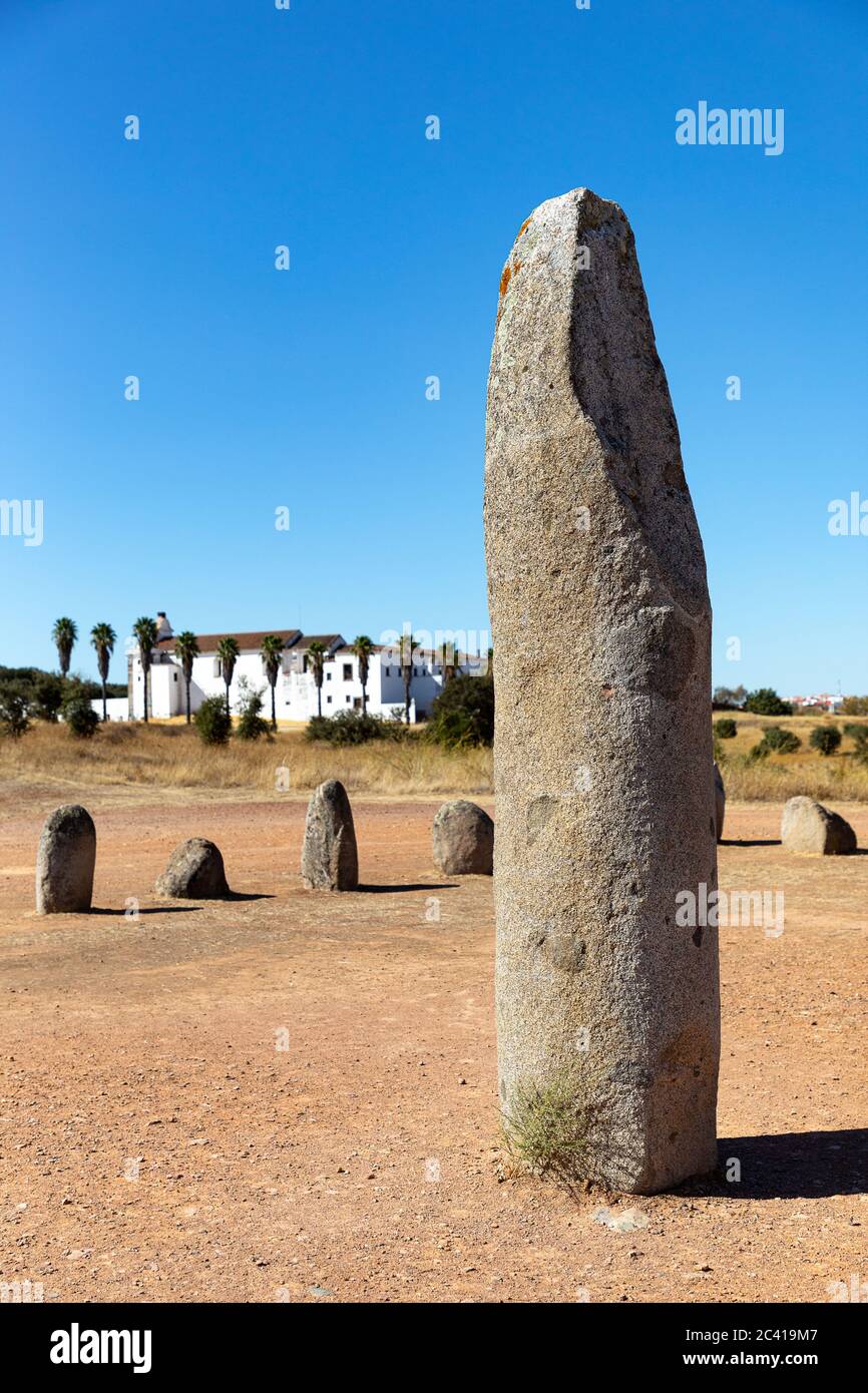 Xerez stone circle (Cromeleque do Xerez), a standing stone quadrant near Monsaraz, Portugal with Convento da Orada in background Stock Photo