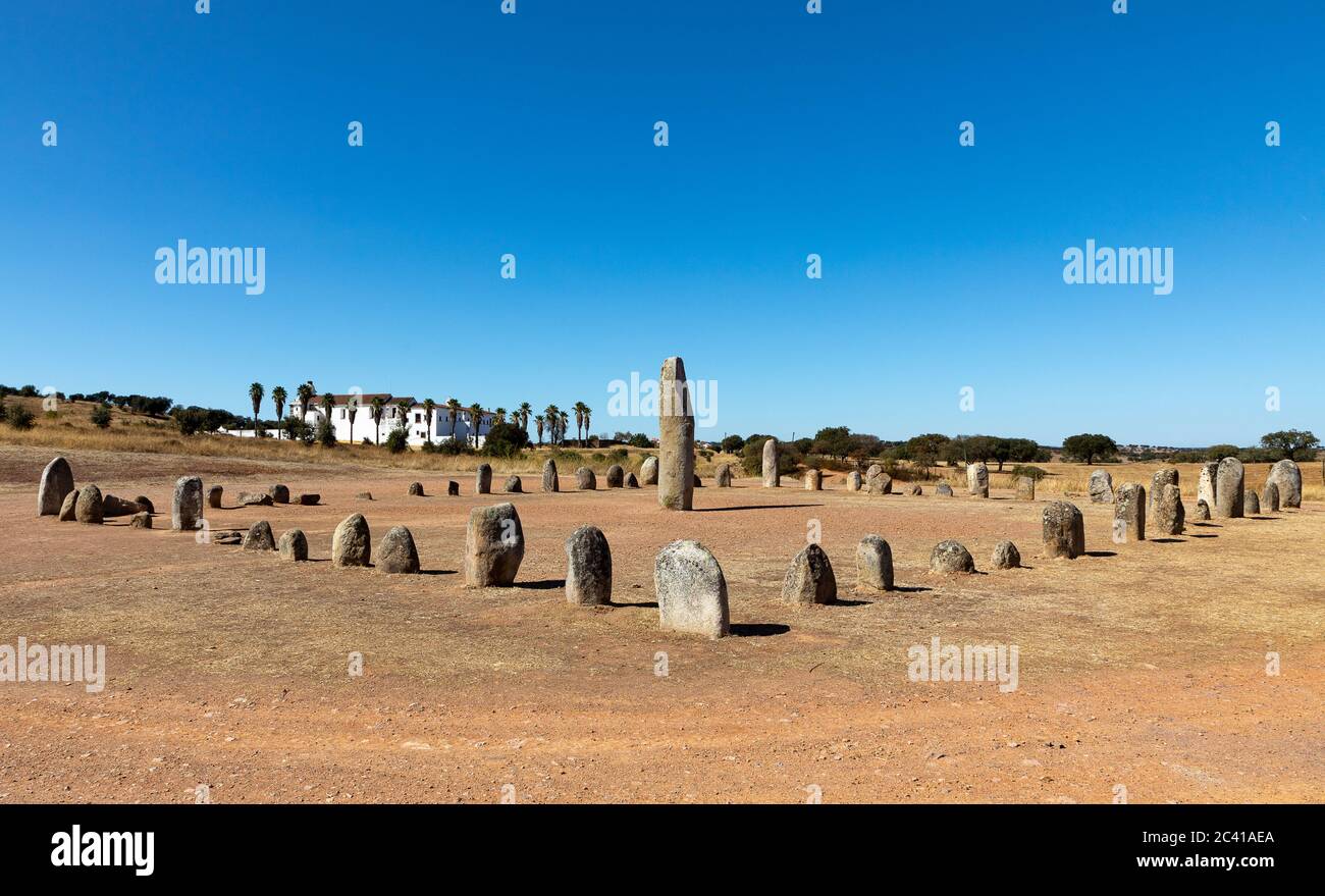 Xarez stone circle (Cromeleque do Xerez), a standing stone quadrant near Monsaraz, Portugal with Convento da Orada in background Stock Photo