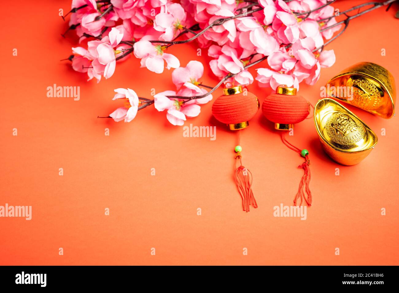 Chinese New Year background. The wordings on gold bar is chinese words which means “to bring in wealth and treasure” Stock Photo