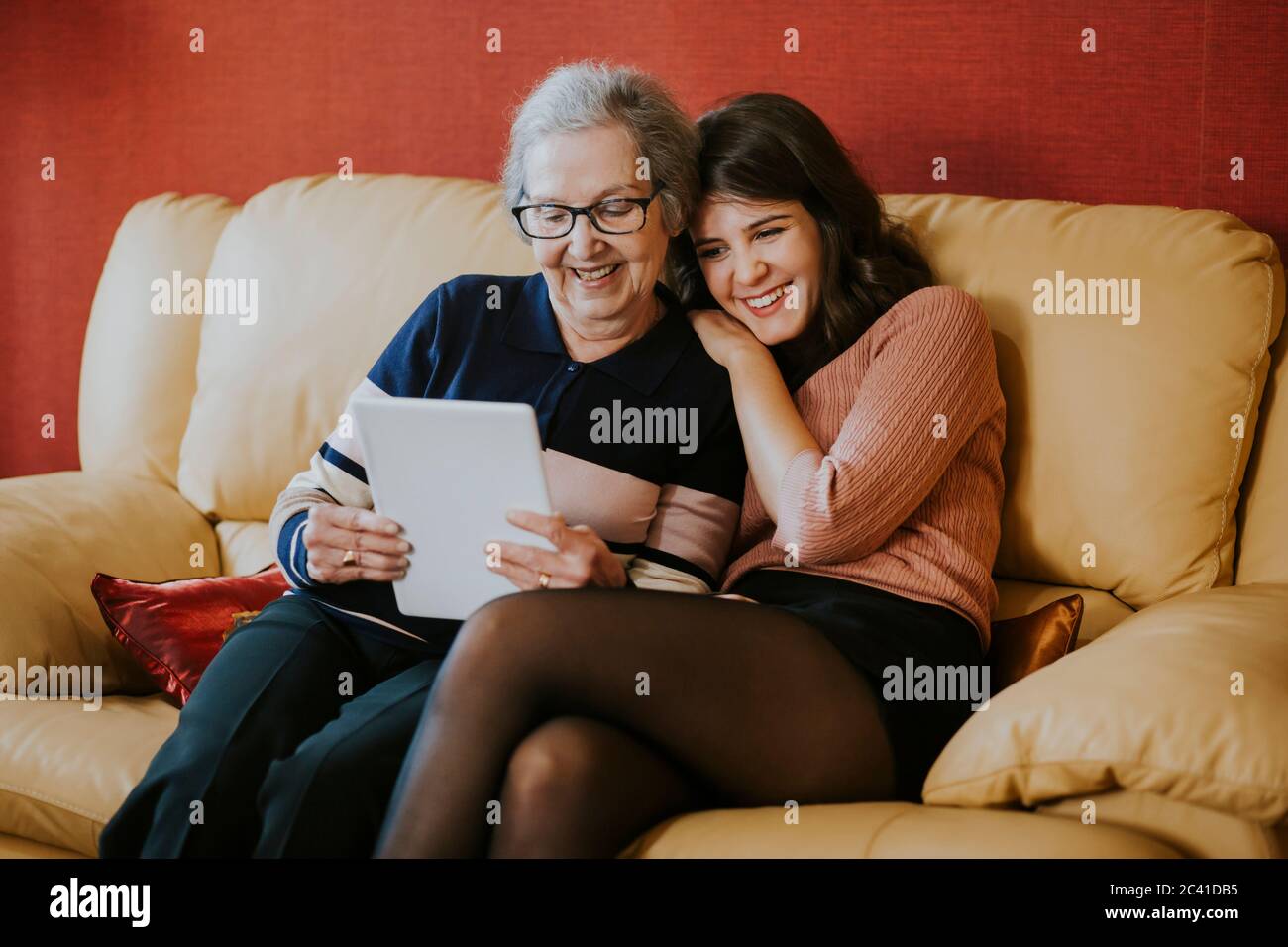 granddaughter and grandmother watching something on the tablet Stock Photo