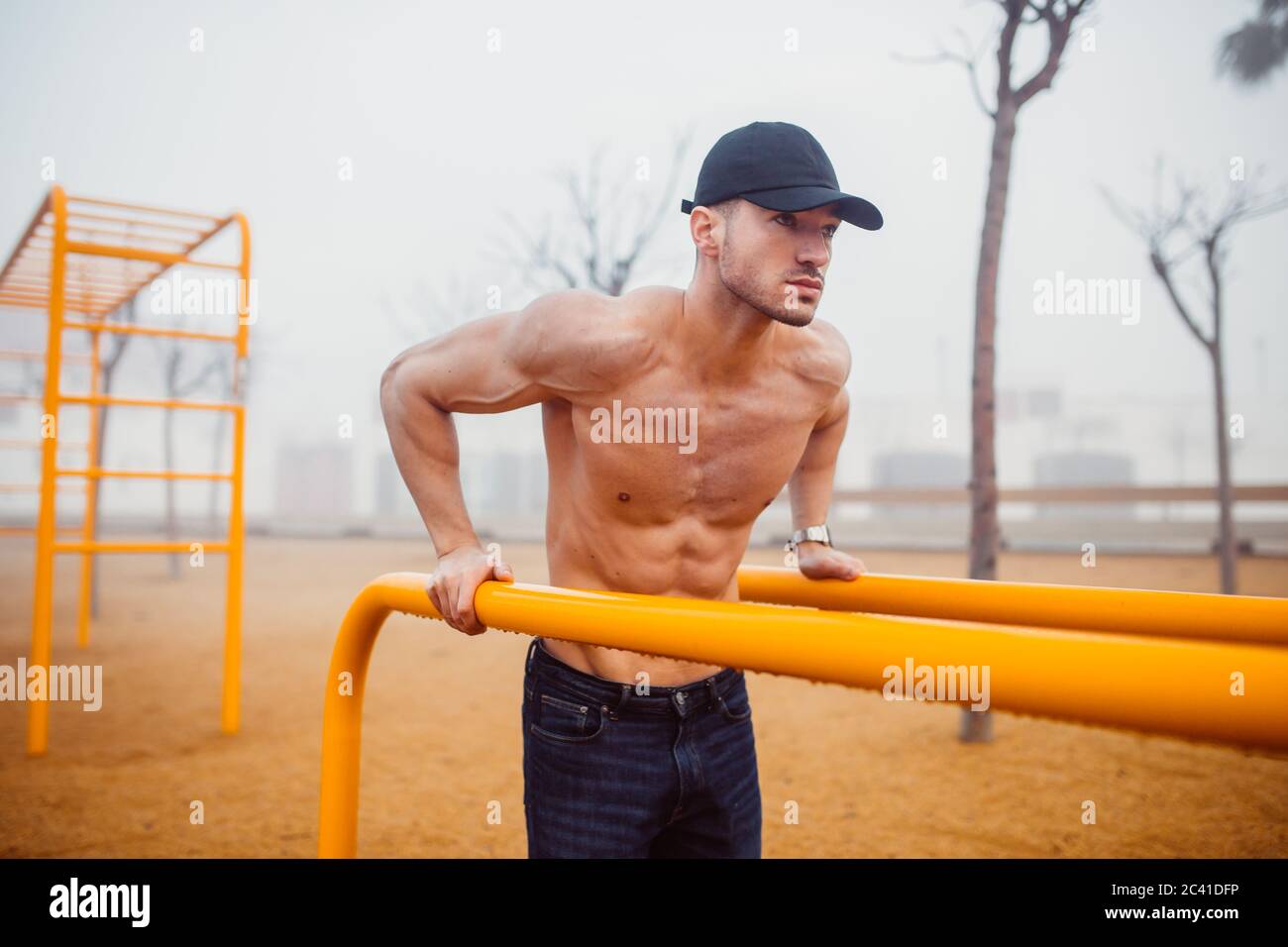 athletic man doing exercises for triceps in a calisthenics park Stock Photo