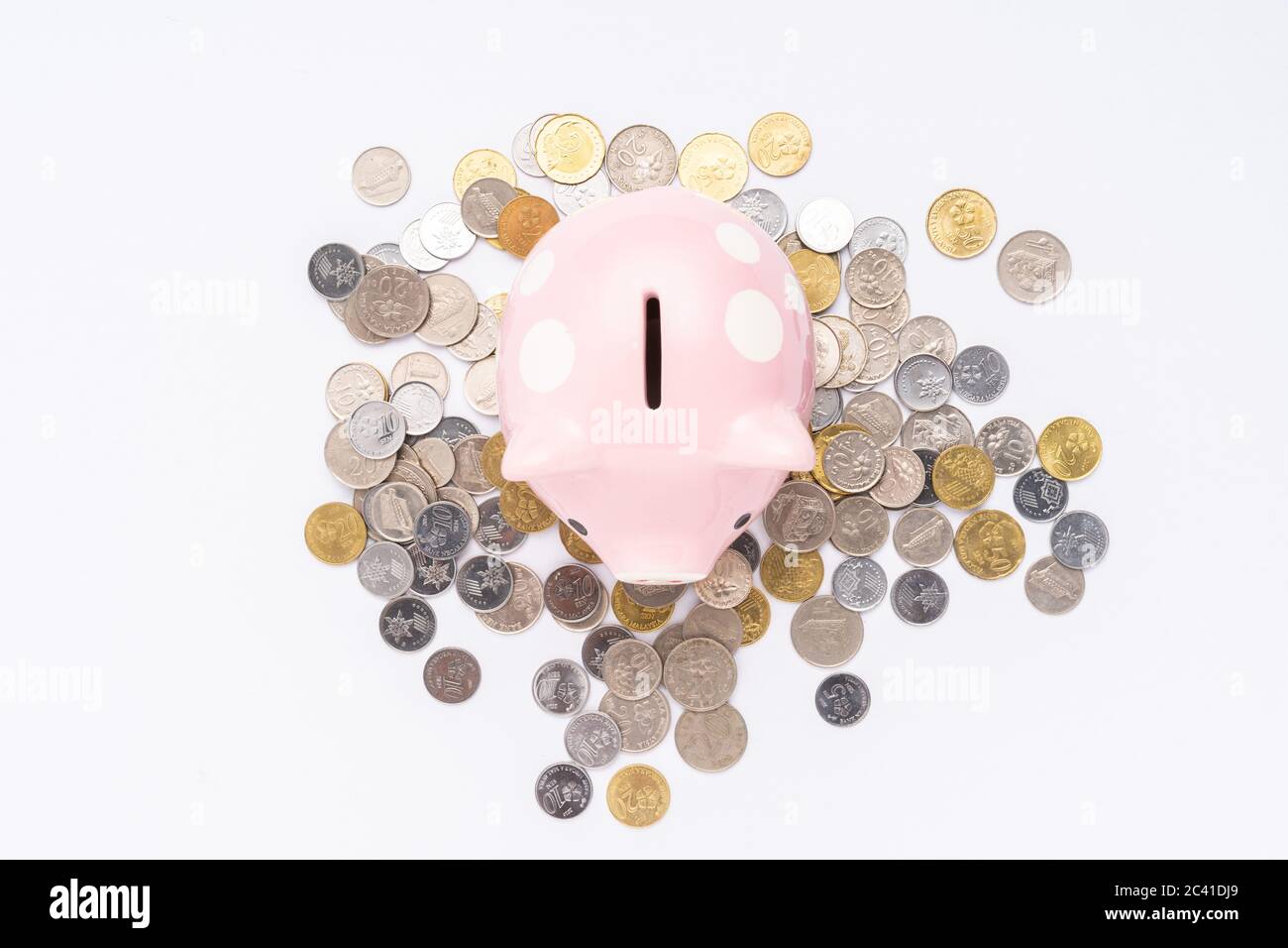 Piggy bank with scattered coins on white background Stock Photo - Alamy