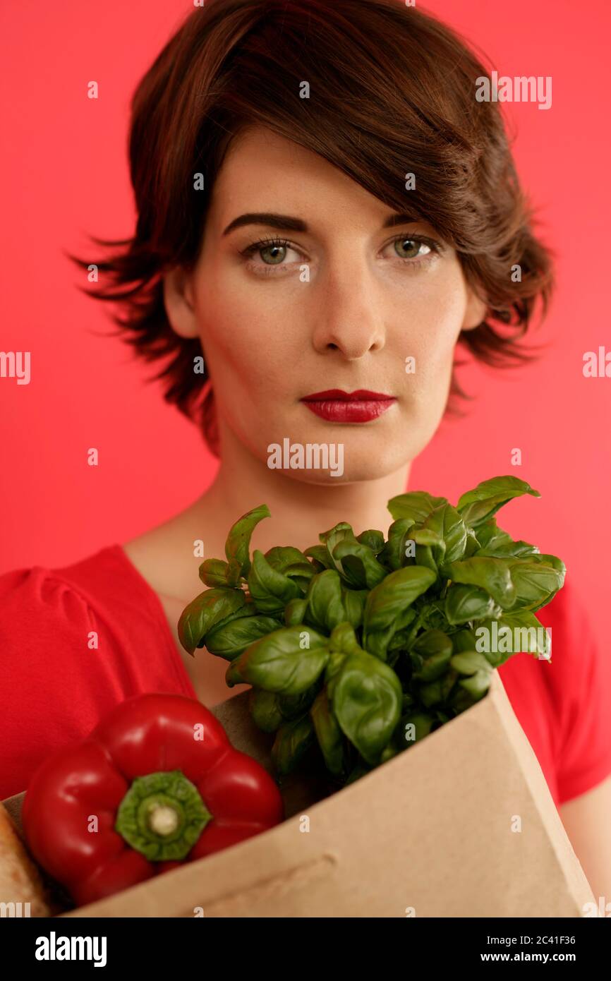 Woman holds grocery bag in her
