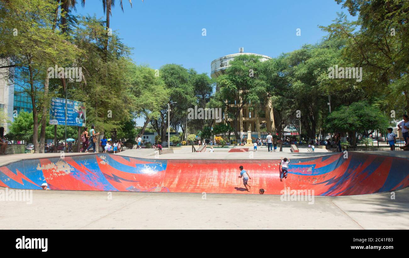 San Miguel de Piura, Piura / Peru - April 5 2019: Children playing on the skating rink of Miguel Cortes Park in the center of the city Stock Photo