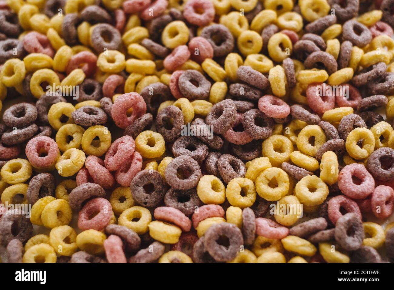 Multi-colored corn rings for breakfast, texture background. Stock Photo