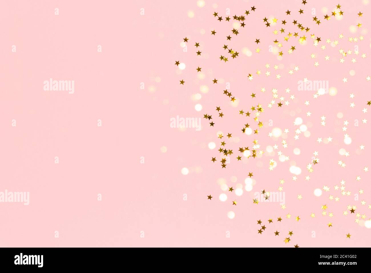 Gold stars confetti scattered on a pink pastel background. Festive ...