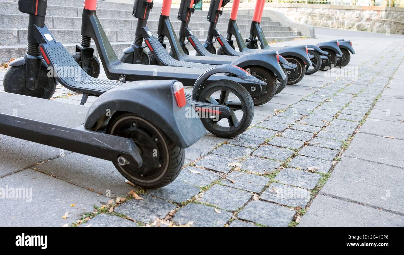 Close up view of electric scooters lined up on the sidewalk in Turku, Finland. Stock Photo