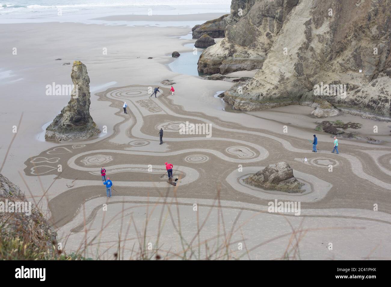 People walking a Circles in the Sand labyrinth at Face Rock Beach in Bandon, Oregon, USA. Stock Photo