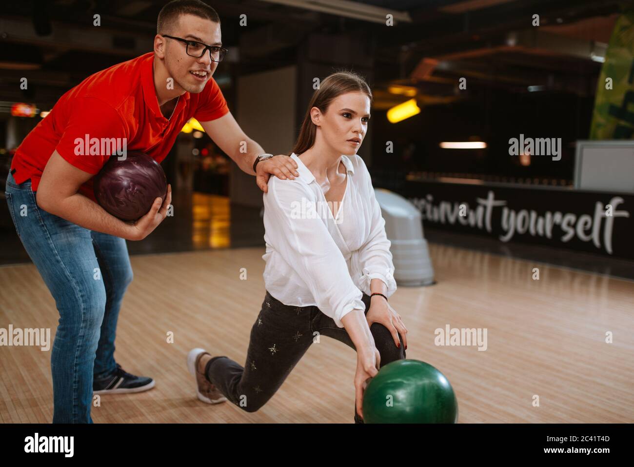 A beautiful loving caucasian couple throwing balls on the bowling alley.  Boyfriend and girlfriend at the bowling club Stock Photo - Alamy