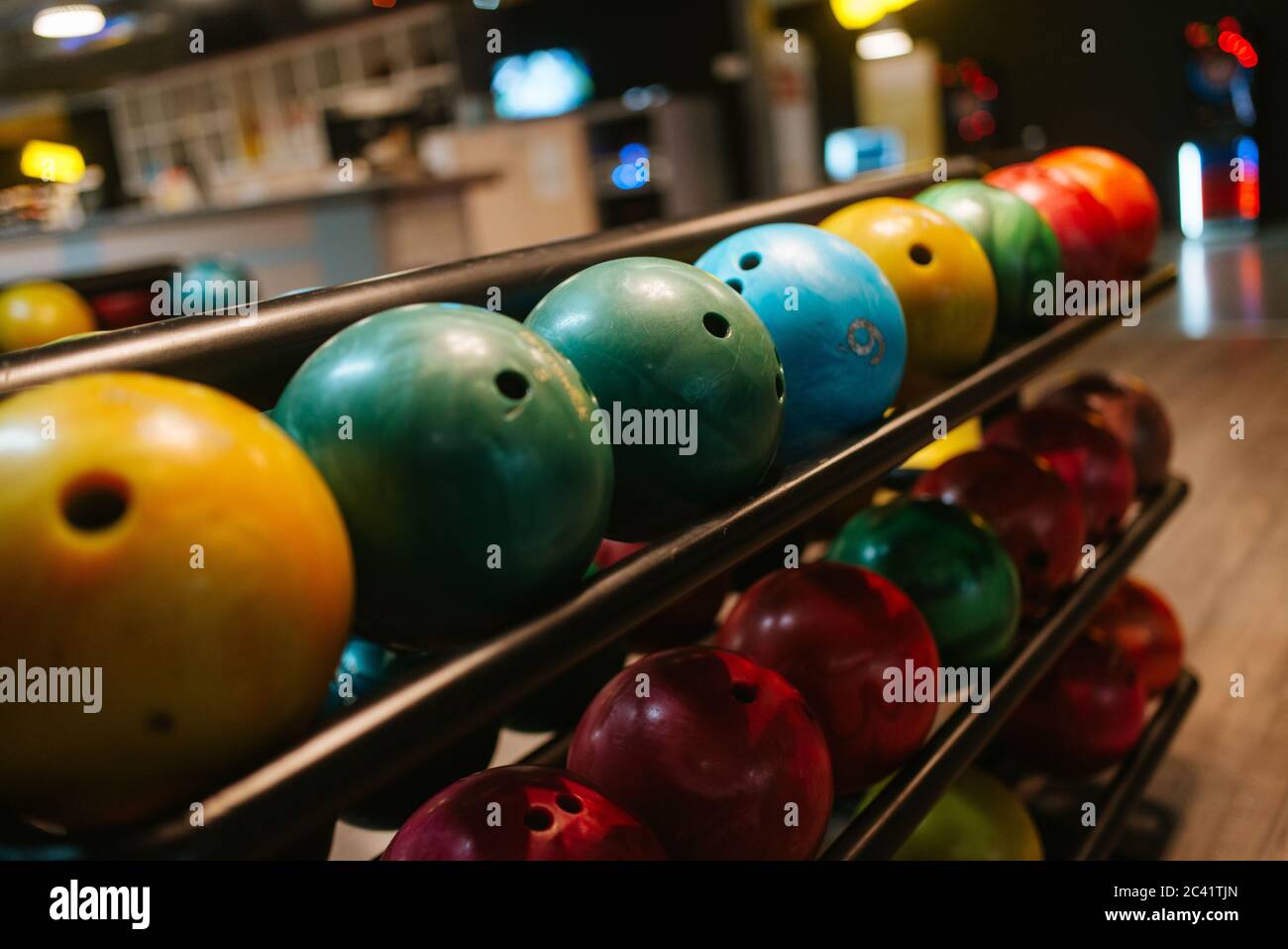 Multicolored bowling balls on the shelf in the bowling club Stock Photo