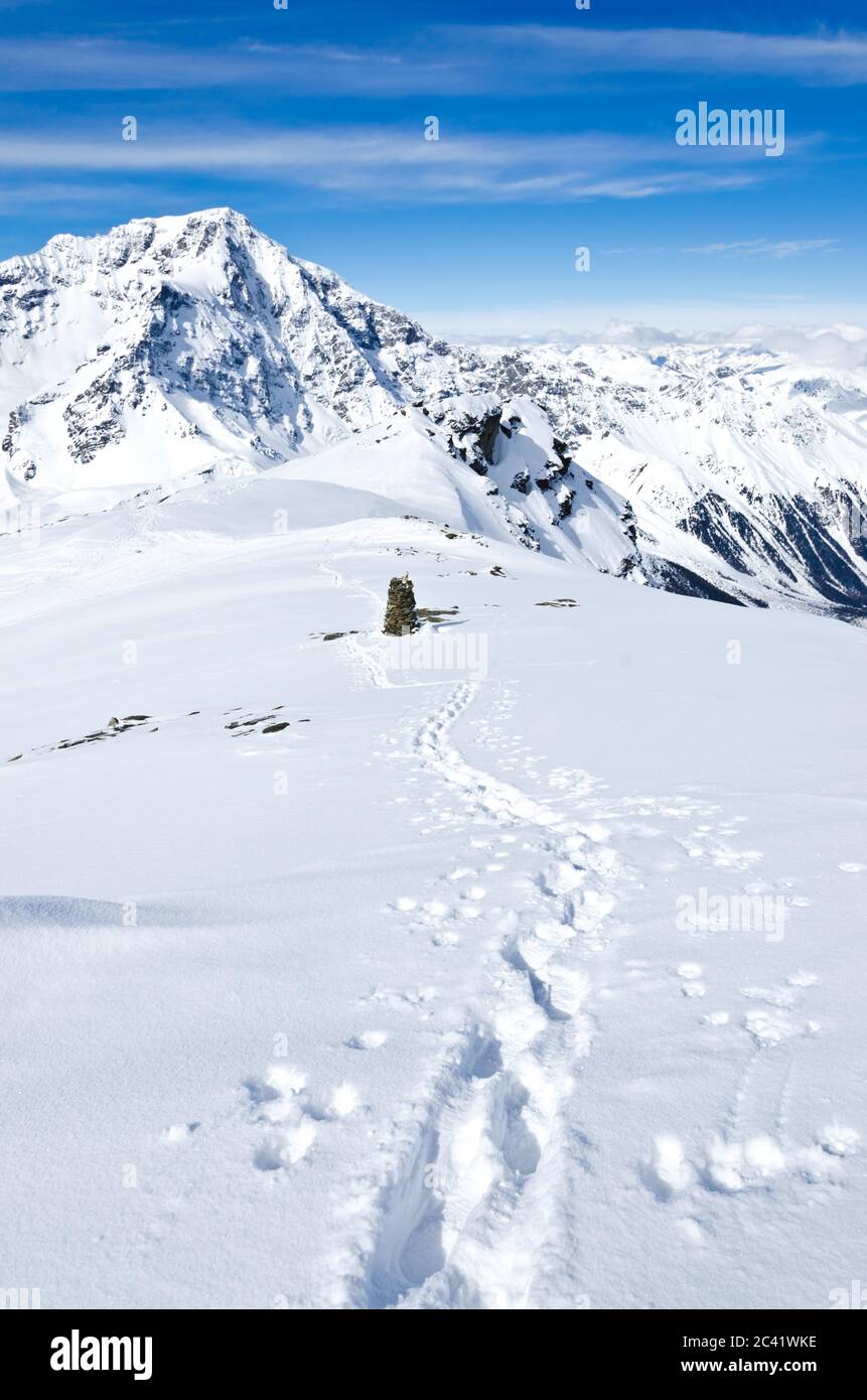 Track in the deep snow on a mountain summit in winter Stock Photo