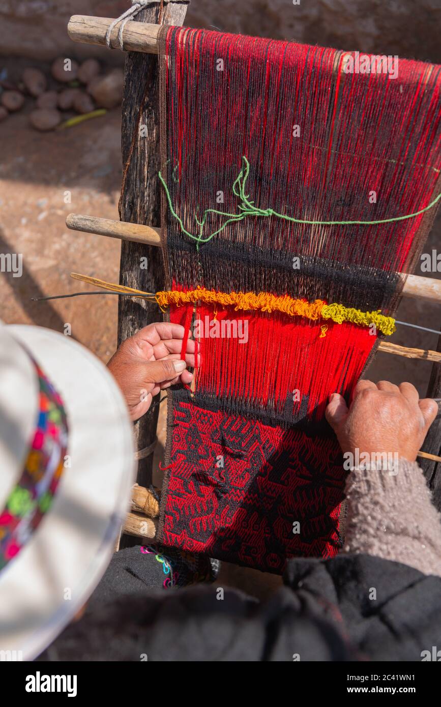 Elderly woman weaver weaving local red and black Jalq´a art pattern,  Potolo, Departamento Chuquisaca, Bolivia, Latin America Stock Photo