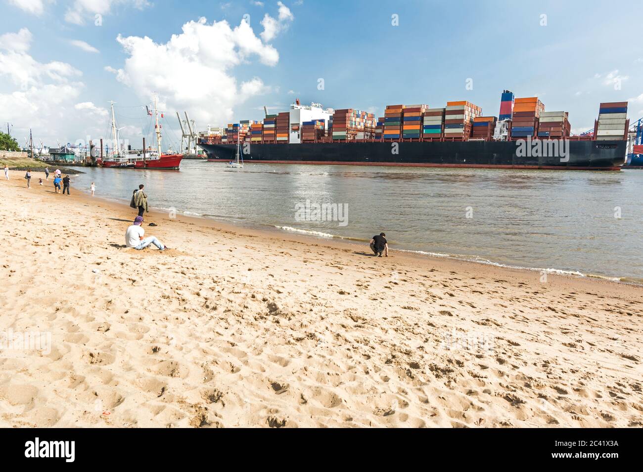 City beach in Hamburg, Germany with large container vessel in the background Stock Photo