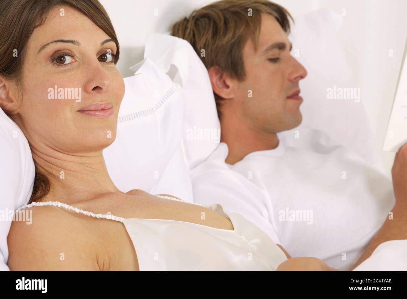 Couple is lying in bed Stock Photo Alamy