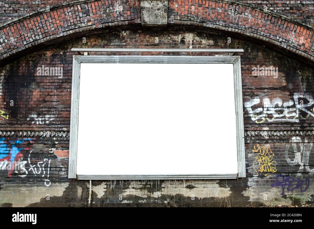 Blank billboard on dark red brick wall with graffiti Stock Photo