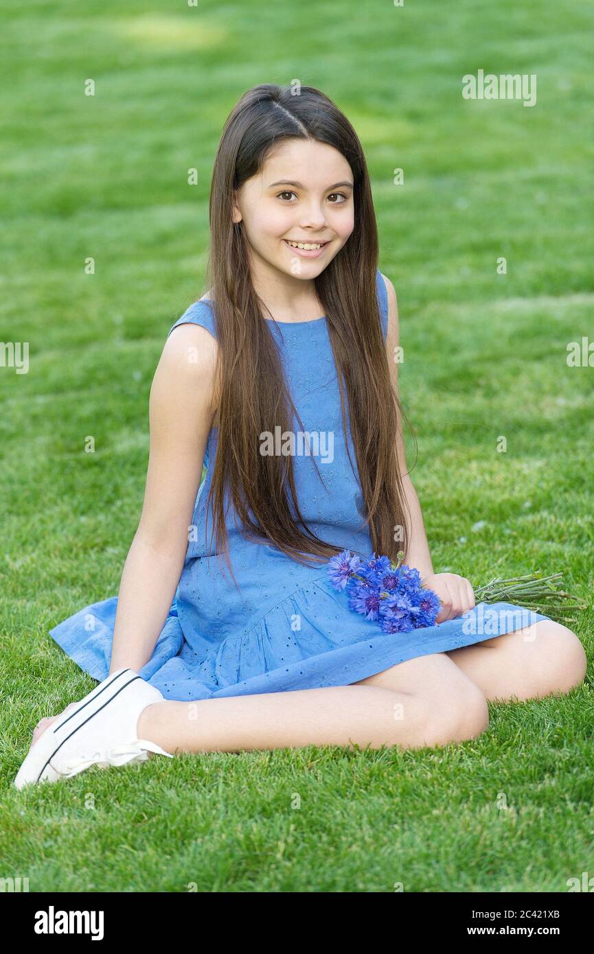 Salon haircare you will love. Little child sit on green grass. Small