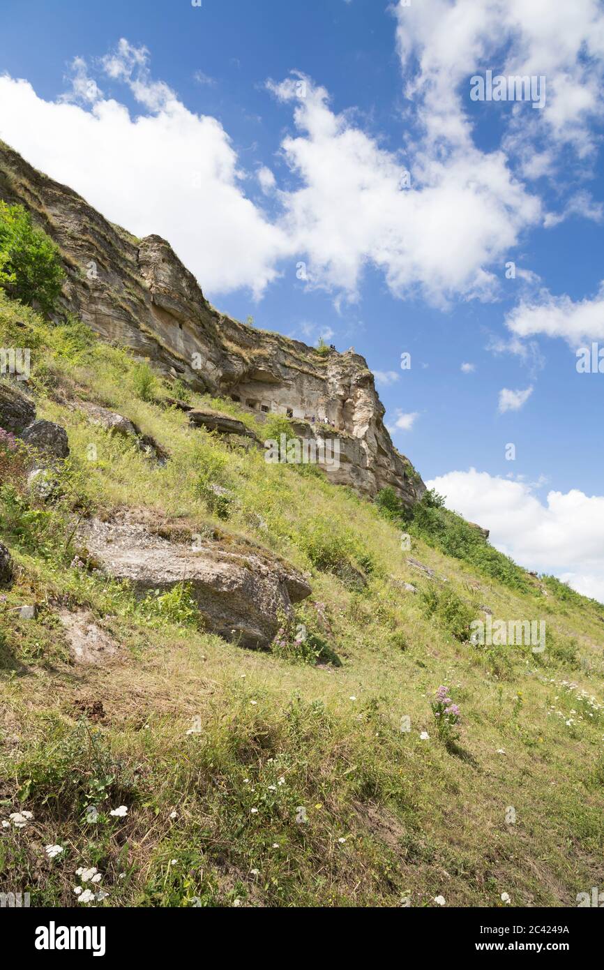 View of a gentle slope. Rocks and the blue sky with clouds Stock Photo
