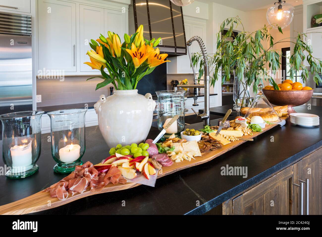 delicious appetizer on a charcuterie board made from Italian olive wood on a Brazilian soapstone kitchen counter Stock Photo