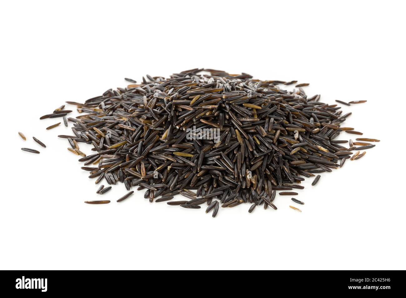 Heap of uncooked, raw, black wild rice grains over white background Stock Photo