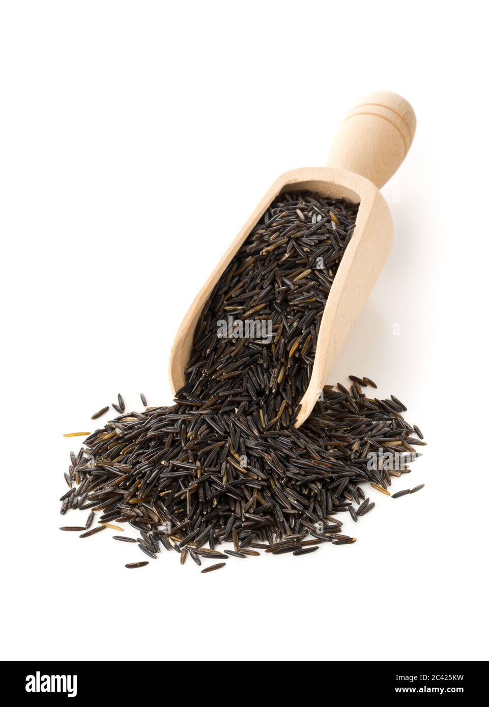 Heap of uncooked, raw, black wild rice grains in wooden scoop over white background, selective focus Stock Photo
