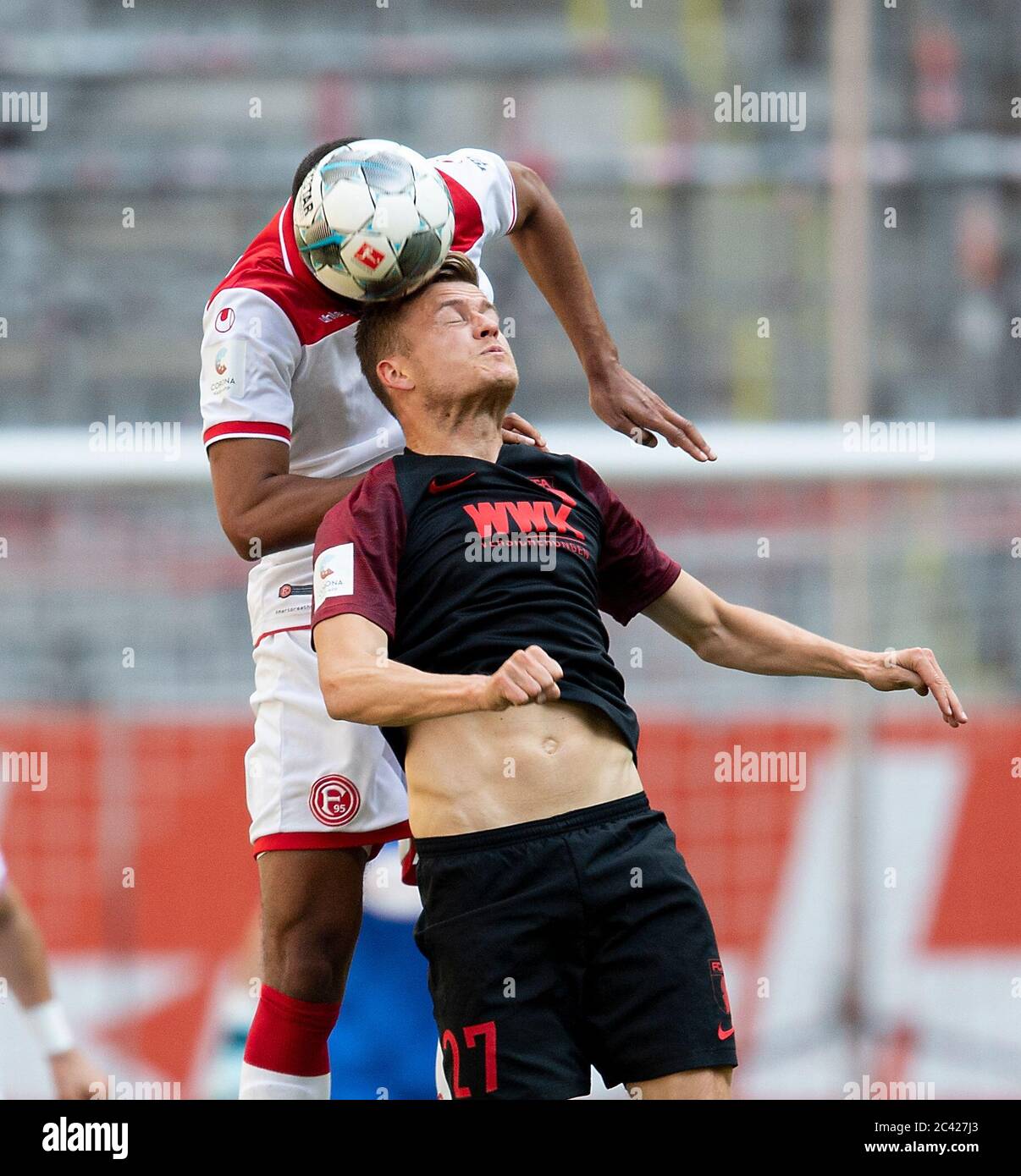 Esprit Arena Duesseldorf Germany 20.6.2020, Football: Bundesliga season 2019/20 matchday 33, Fortuna Duesseldorf (F95, white) vs FC Augsburg (FCA, black) —  Alfred FINNBOGASON  (FCA) beim Kopfball gegen Mathias JOERGENSEN (F95) Due to the Corona pandemic, matches are played in empty stadiums without spectators  credit: AnkeWaelischmiller/Sven Simon/ Pool/via Kolvenbach  # Editorial use only # # DFL regulations prohibit any use of photographs as image sequences and/or quasi-video # # National and international news- agencies out # Stock Photo