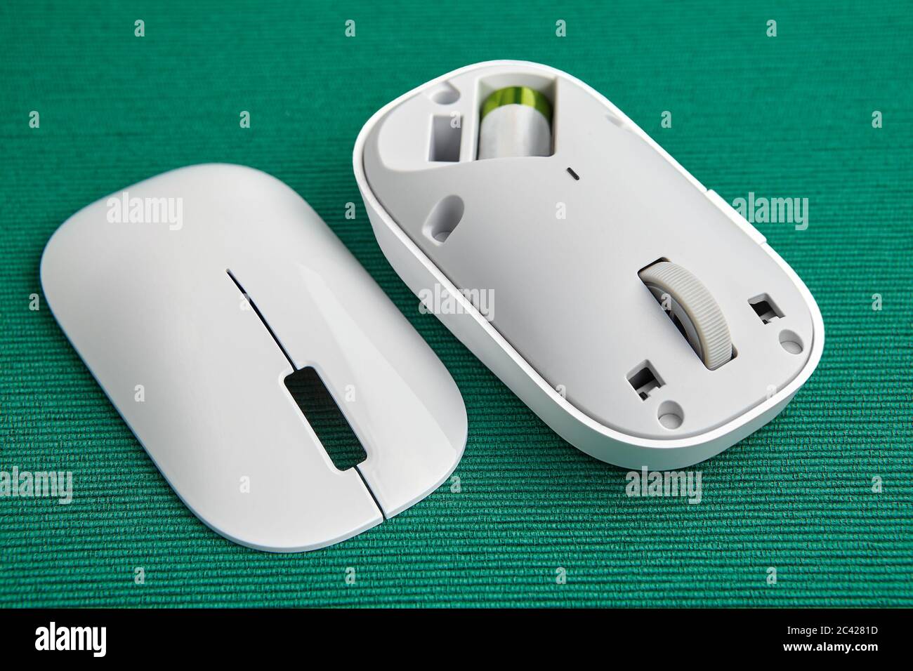 White wireless computer mouse with a removed magnetic cover. PC input ...